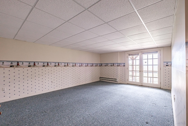 carpeted spare room featuring a paneled ceiling