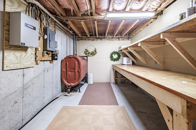 unfinished basement featuring heating fuel and electric panel