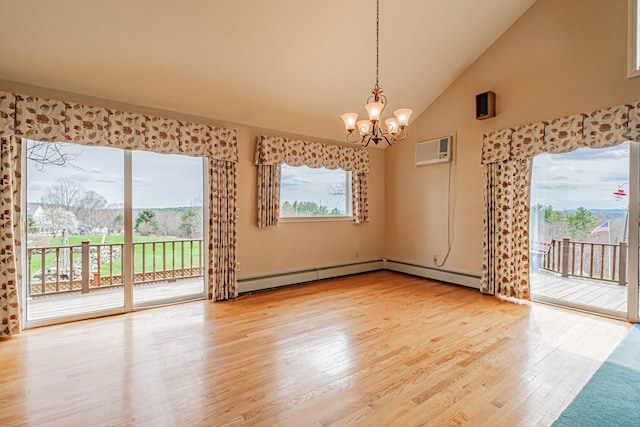 spare room with a wall mounted air conditioner, wood finished floors, high vaulted ceiling, a baseboard radiator, and a chandelier