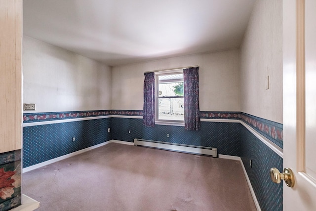 carpeted spare room featuring baseboards, wallpapered walls, and baseboard heating