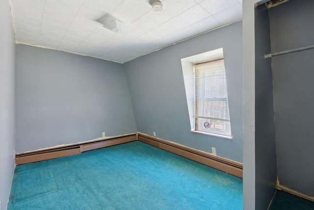 carpeted spare room with baseboard heating