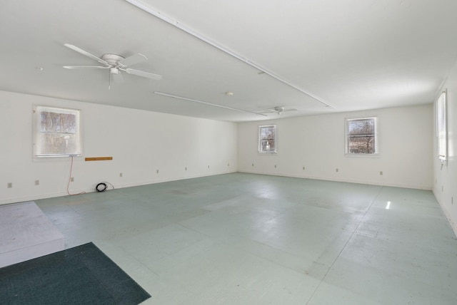 spare room with ceiling fan and baseboards