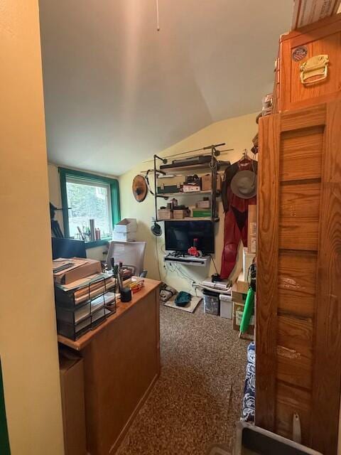 carpeted office space featuring lofted ceiling