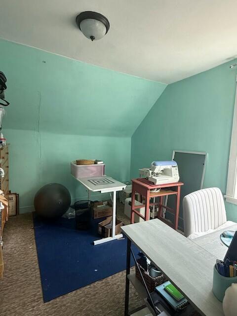office with carpet flooring and lofted ceiling