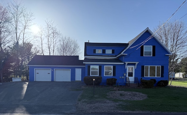94 Dexter Rd, Corinna, ME 04928 - traditional home featuring an attached garage, driveway, and a front lawn