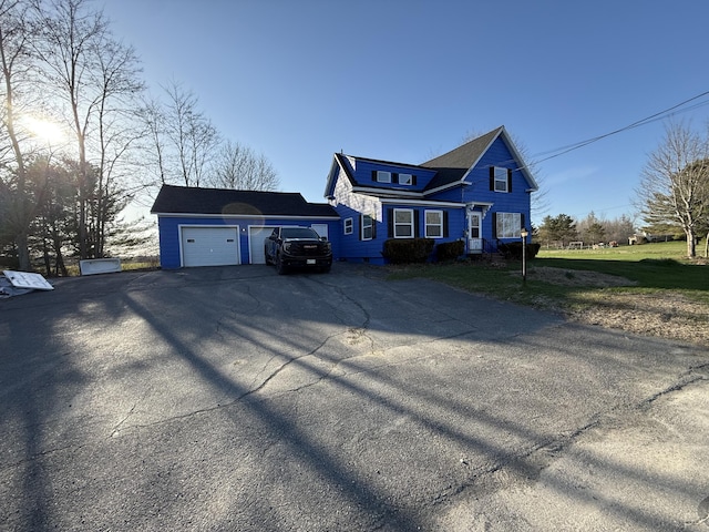 94 Dexter Rd, Corinna, ME 04928 - view of front of home featuring an attached garage, driveway, and a front lawn