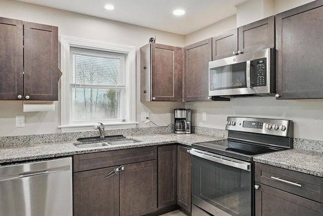 66 Balsam Dr, Windsor, ME 04363 - kitchen with appliances with stainless steel finishes, a sink, dark brown cabinets, light stone counters, and recessed lighting