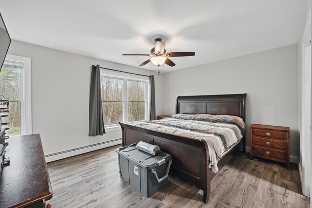 66 Balsam Dr, Windsor, ME 04363 - bedroom with a baseboard heating unit, wood finished floors, and ceiling fan