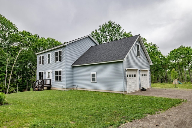 66 Balsam Dr, Windsor, ME 04363 - view of side of home featuring a shingled roof, driveway, a garage, a yard, and view of scattered trees