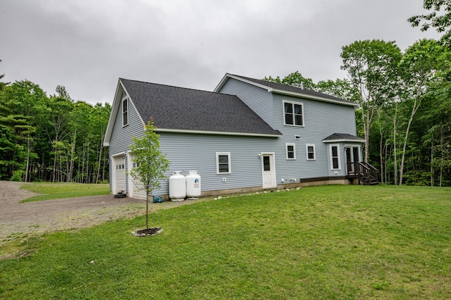66 Balsam Dr, Windsor, ME 04363 - rear view of house with dirt driveway, roof with shingles, an attached garage, and a lawn
