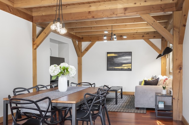 dining space featuring dark wood finished floors, beam ceiling, and baseboards