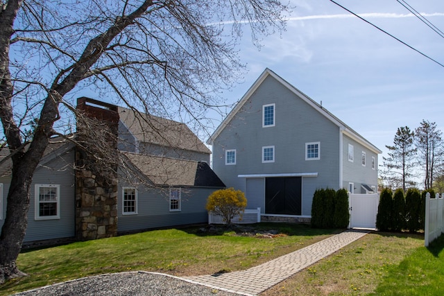 back of house with a chimney
