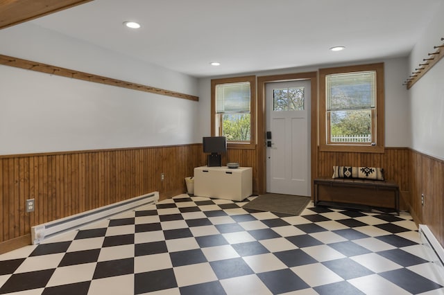 entrance foyer with a wainscoted wall, baseboard heating, wood walls, tile patterned floors, and recessed lighting