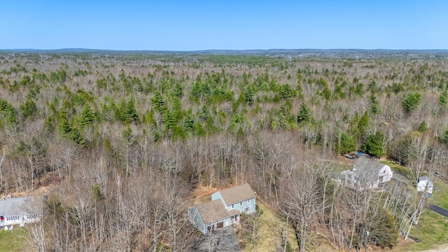 birds eye view of property featuring a wooded view