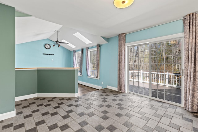 interior space with ceiling fan, baseboards, a baseboard heating unit, and a wealth of natural light