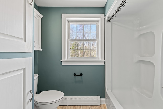 full bath featuring a shower, wood finished floors, baseboards, a baseboard radiator, and toilet