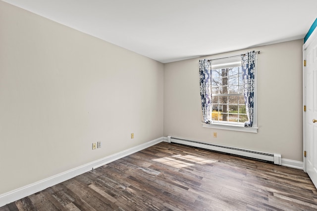 spare room featuring baseboards, baseboard heating, and wood finished floors