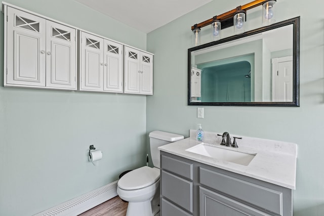 bathroom featuring vanity, a baseboard heating unit, and toilet