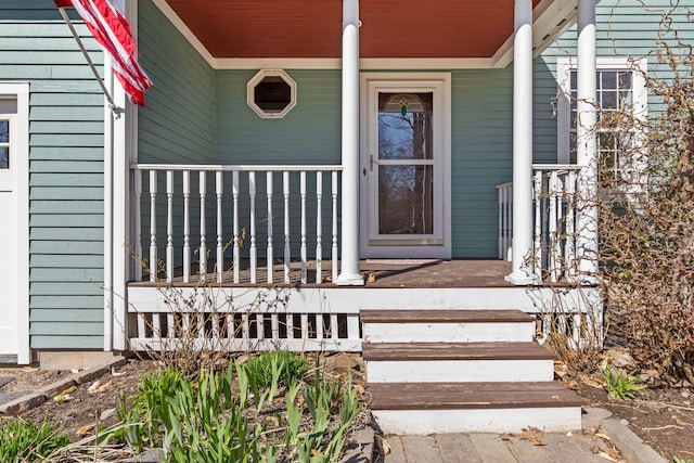 view of exterior entry featuring a porch