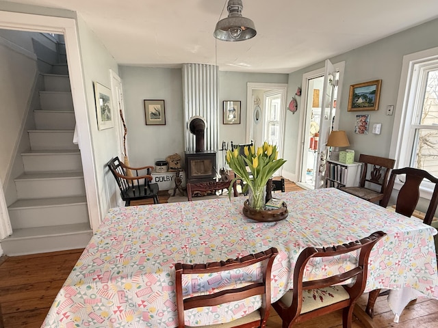 7 Mountain St, Vinalhaven, ME 04863 - dining area featuring wood finished floors, stairway, and a wood stove