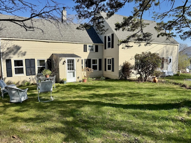 7 Mountain St, Vinalhaven, ME 04863 - back of property with a lawn, a chimney, and roof with shingles