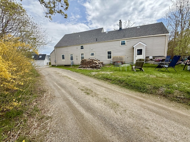 7 Mountain St, Vinalhaven, ME 04863 - back of property featuring a lawn and driveway