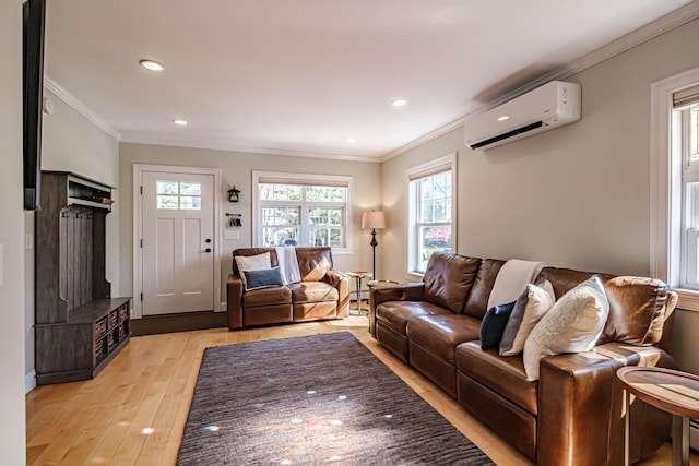 living area with crown molding, recessed lighting, a wall mounted AC, and light wood-style flooring