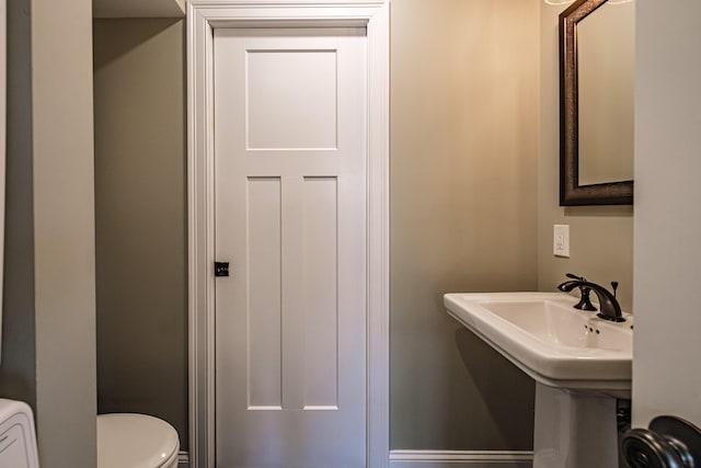 half bath with toilet and a sink