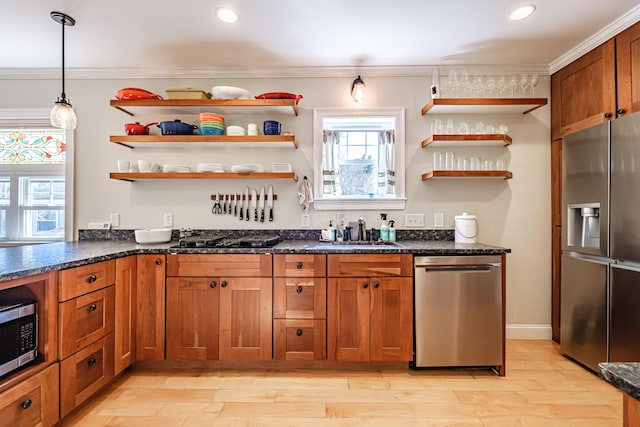 kitchen featuring crown molding, open shelves, brown cabinets, a sink, and appliances with stainless steel finishes
