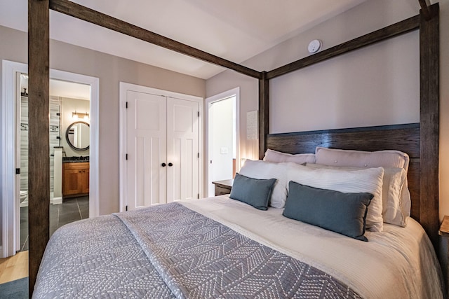 bedroom featuring a closet and ensuite bath