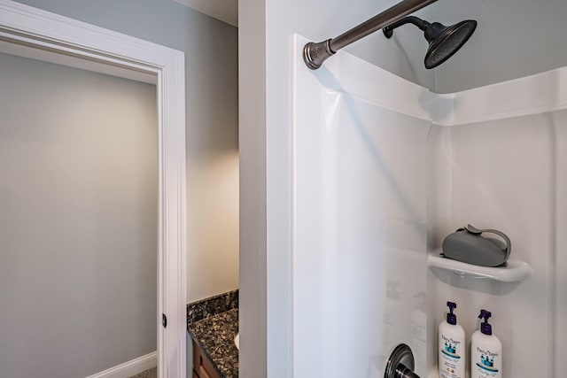 full bathroom with vanity and baseboards
