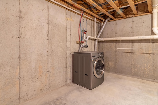unfinished below grade area featuring washer / dryer