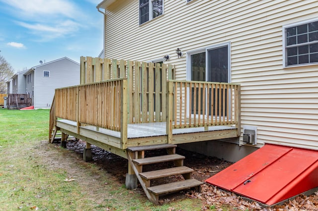 wooden deck featuring a yard