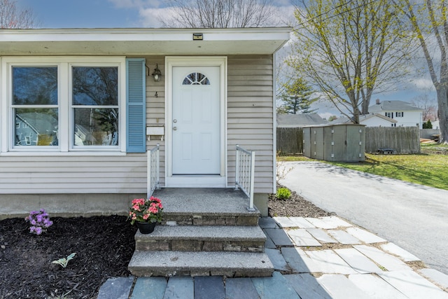 doorway to property featuring fence