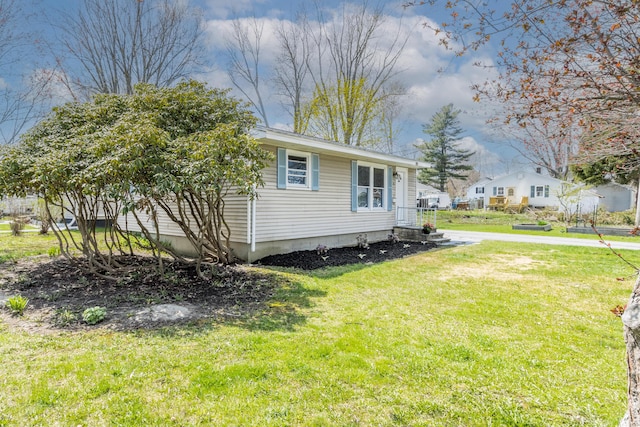 view of side of property with a yard