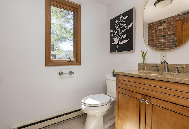 bathroom with tile patterned floors, a baseboard radiator, vanity, and toilet