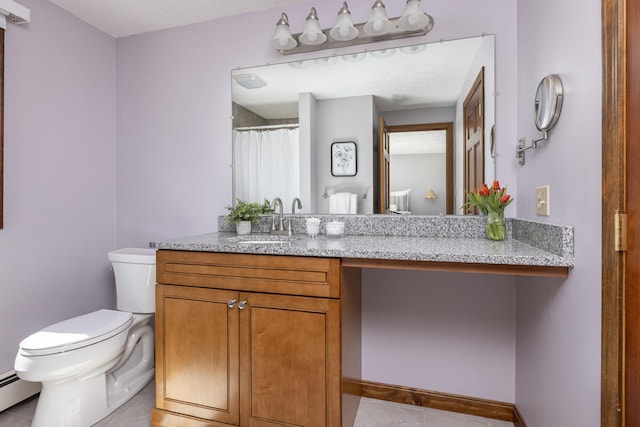 bathroom featuring vanity, tile patterned floors, a baseboard heating unit, and toilet