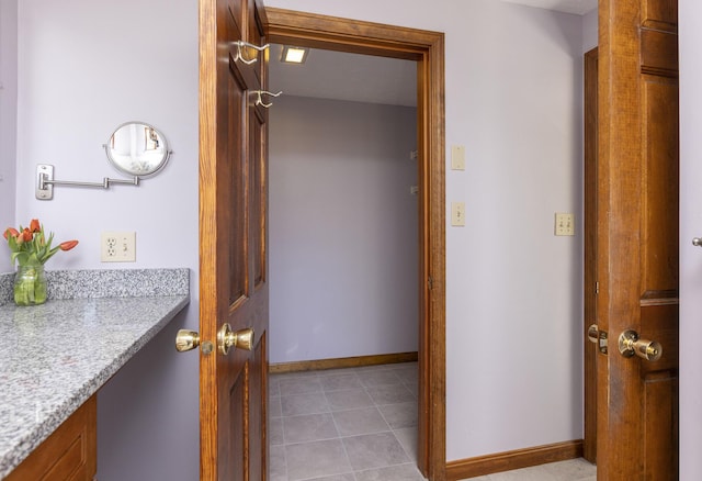 bathroom featuring vanity, baseboards, and tile patterned flooring
