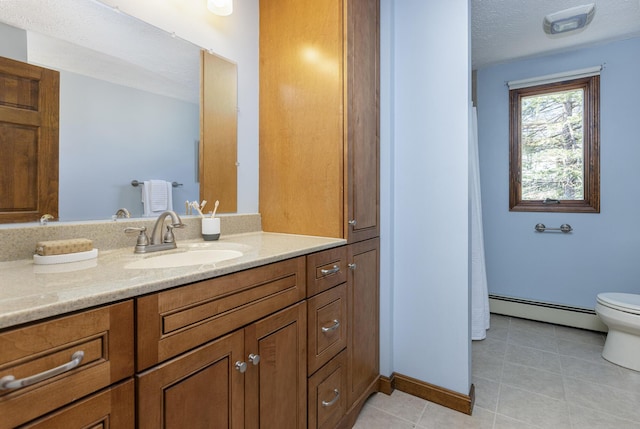 bathroom with vanity, tile patterned floors, baseboard heating, and toilet