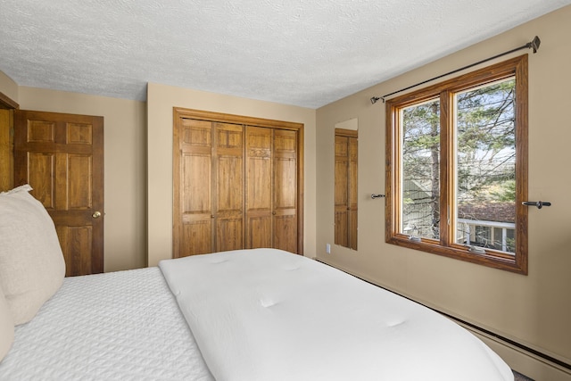 bedroom with a textured ceiling and a closet