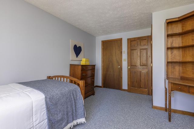 bedroom with carpet floors, a textured ceiling, and baseboards