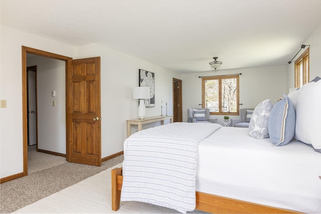 bedroom featuring carpet floors and baseboards
