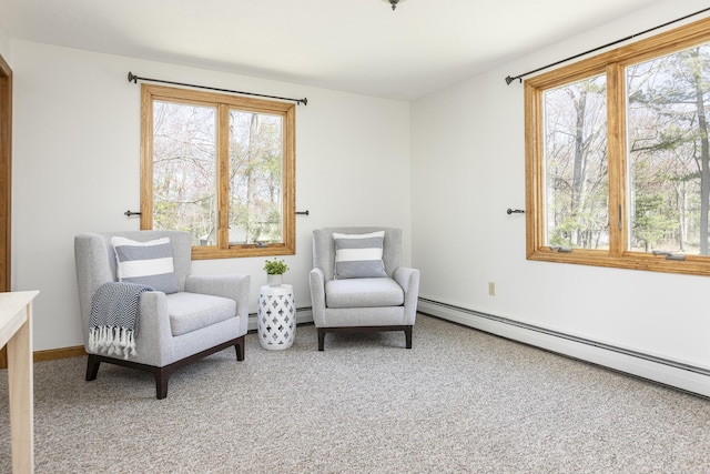 sitting room with carpet, baseboard heating, and a wealth of natural light