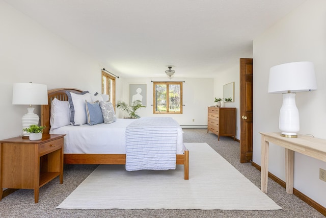 bedroom with baseboards and light colored carpet