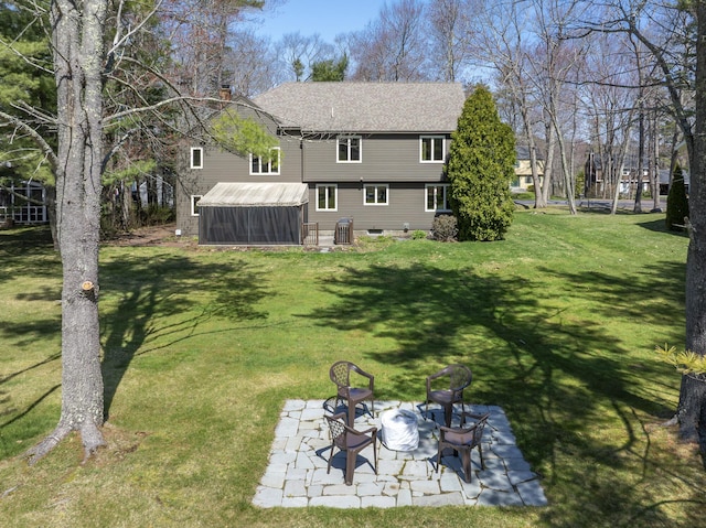 view of yard featuring a sunroom, cooling unit, an outdoor fire pit, and a patio