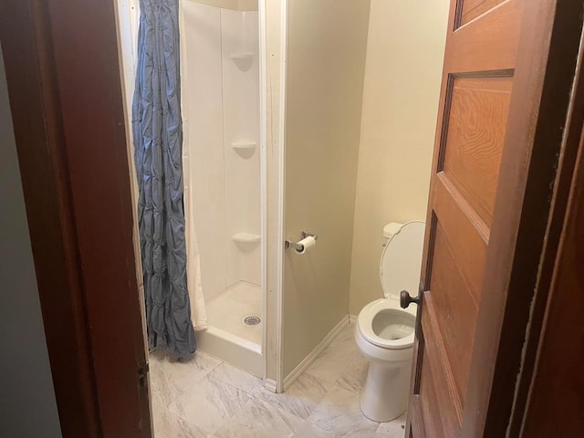 full bath featuring baseboards, a stall shower, toilet, and marble finish floor