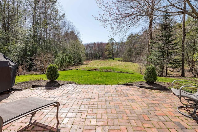 view of patio / terrace featuring a view of trees