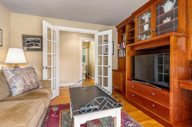 living room with light wood-style floors and french doors