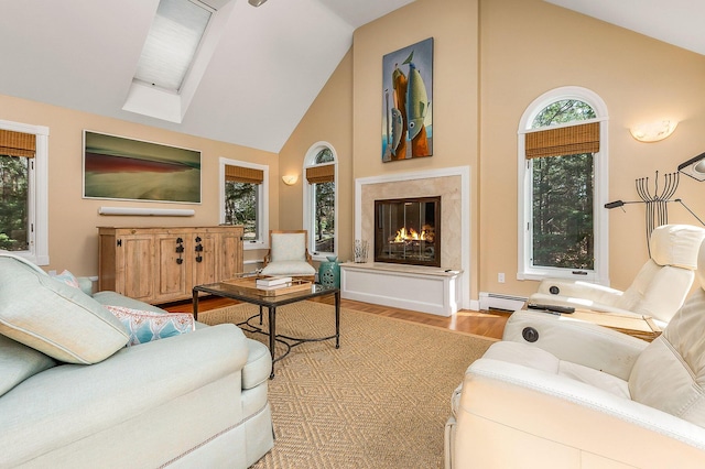 living room with high vaulted ceiling, baseboard heating, wood finished floors, and a premium fireplace