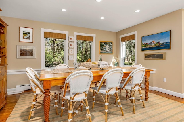 dining room with light wood-style floors, baseboards, and recessed lighting